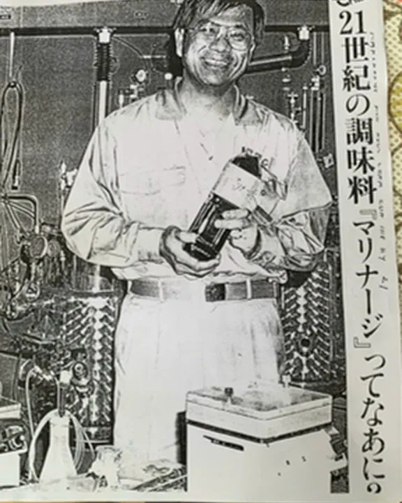 Dr. Duong Qua Aita in the laboratory holding a bottle of Marinage, from a Japanese press feature