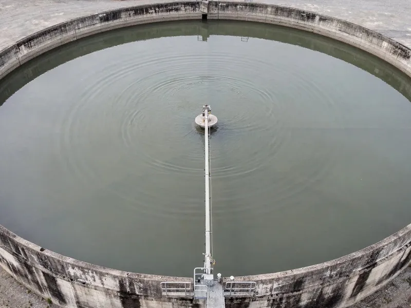 A circular wastewater treatment clarifier seen from above